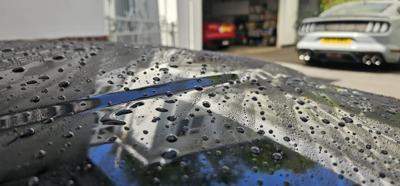 Autoglym Hi-Def Wax water beading on protected black paintwork